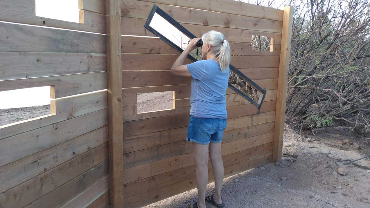 A guest enjoys observing birds from the blind.